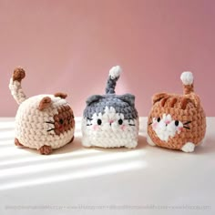 three small crocheted cats sitting next to each other