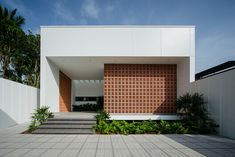 the entrance to a modern house with steps leading up to it