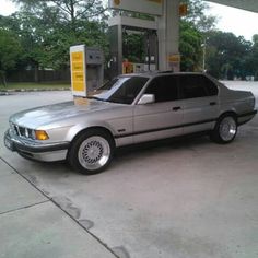 a silver car parked in front of a gas station