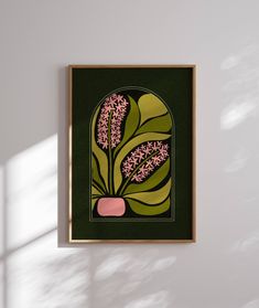 a painting hanging on the wall next to a vase with pink flowers and green leaves