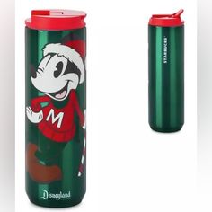 a mickey mouse travel mug next to a red and green cup with the word m on it