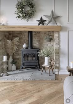 a living room filled with furniture and a wood burning stove in the middle of it