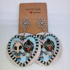 two heart shaped earrings with cartoon characters on them