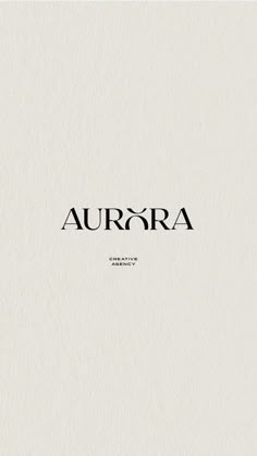 the word aurora is written in black ink on a white paper with an elegant font