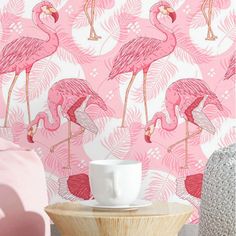 pink flamingos and palm leaves wallpaper in a living room with a coffee table