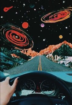 a person is driving down the road in front of an image of planets