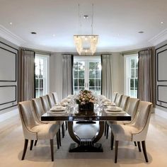 a dining room table with chairs and a chandelier