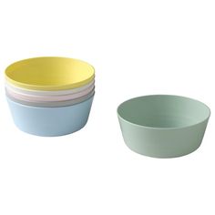 four different colored bowls sitting next to each other