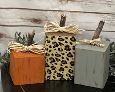 three small wooden blocks sitting on top of a table