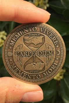 a person holding up a bronze coin with the words women to vivrers on it