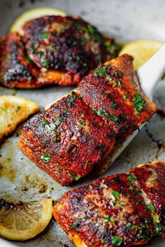 grilled salmon with lemon wedges and parsley