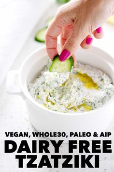 a hand dipping a cucumber into a bowl of dip with the text vegan, whole 30 paleo & air dairy free tataziki