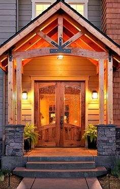 an entry way to a home with lights on and steps leading up to the front door