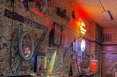 an old bar with graffiti all over the walls