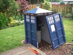 a tardist shaped box sitting in the middle of a yard