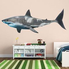 a shark wall decal in a child's room with a bed and dresser