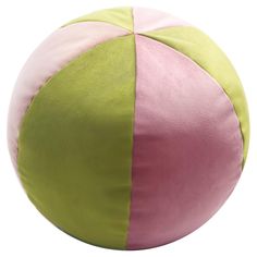 a large pink and green ball sitting on top of a white floor