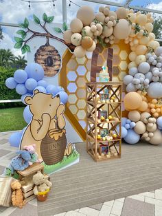 balloons and winnie the pooh decorations are on display