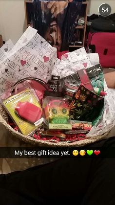 a basket filled with lots of different types of candy and candies on top of a bed