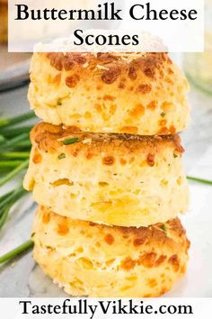 three cheesy biscuits stacked on top of each other with the words buttermilk cheese