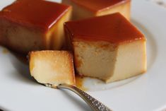 three pieces of caramel cheesecake on a white plate with a fork and spoon