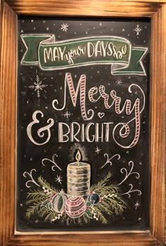 a chalkboard sign that says merry and bright with a lit candle in the center