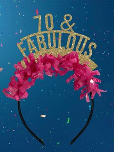 a tiara with the word 90 and fabulous spelled in gold on top, surrounded by confetti