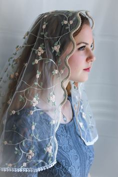 a woman wearing a veil with flowers on it