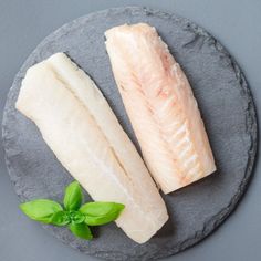 two raw fish fillets on a slate plate