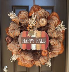 a happy fall wreath hanging on the front door