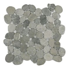 a white and grey tile with small rocks on it