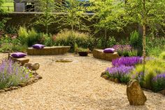 an outdoor garden with rocks and lavenders