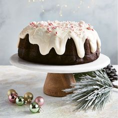 a bundt cake with white frosting and peppermint decorations on a platter