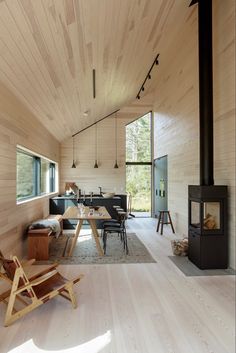 a living room filled with furniture and a wood burning stove in the middle of it