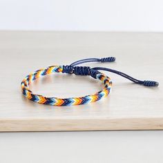 DIY Tuelam welcomes you! Thank you for visiting my store! "The Aroace Bracelet" is hand-braided from nylon cord in the 5 colors of the Aroace pride flag. So it is very durable, very safe, hypoallergenic and comfortable to use. It is not only a bracelet, it will be a witness of your great love. Whether you're showing pride or supporting it with this bracelet, both are equally awesome. Wish the good things for everyone! Adjustable Wrist Size from 14cm - 26cm. If you need a smaller measure or want Adjustable Orange Wristband Bracelet, Pride Flag Bracelet, Aromantic Pride Jewelry, Adjustable Multicolor Bracelets For Pride, Adjustable Multicolor Hand-strung Braided Bracelets, Pride Bracelet, Colorful Bracelets, Great Love, Pride Flags