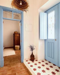 an entry way with blue doors and tile flooring