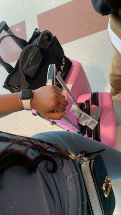 a woman is checking her luggage at the airport