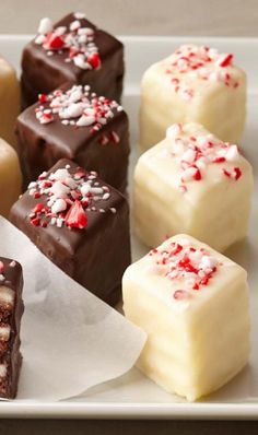 several pieces of cake on a plate with white paper and red sprinkles