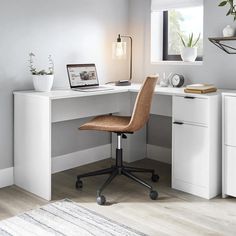 a white desk with a laptop on it and a chair in front of the desk