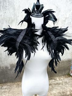 a white mannequin with black feathers on it