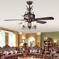 a living room filled with furniture and a ceiling fan