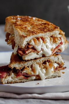 a grilled cheese sandwich with caramelized onions and bacon is on a plate