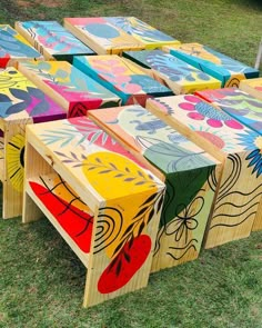 colorful painted wooden benches sitting in the grass