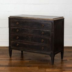 an antique chest of drawers on wooden floors