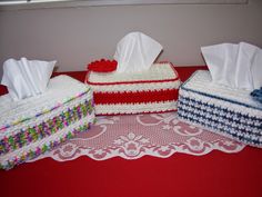 three pieces of cake sitting on top of a table next to each other with tissue paper in them