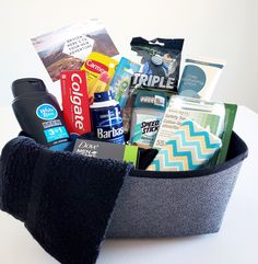 a basket filled with lots of different items on top of a white table next to a black towel