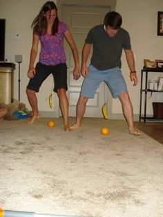 two people are playing with balls in the living room