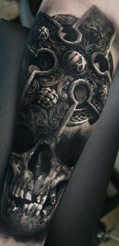 a black and white skull tattoo on the arm