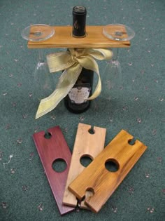 three wine bottle openers sitting next to each other on the floor with a ribbon tied around them