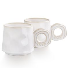 three white cups sitting next to each other